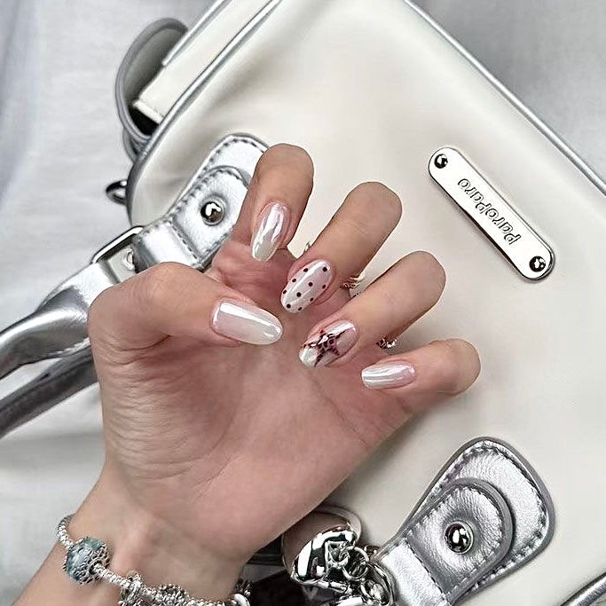 White press-on nails with star and dot designs in a clear case, branded 'DIARYNAILS'.